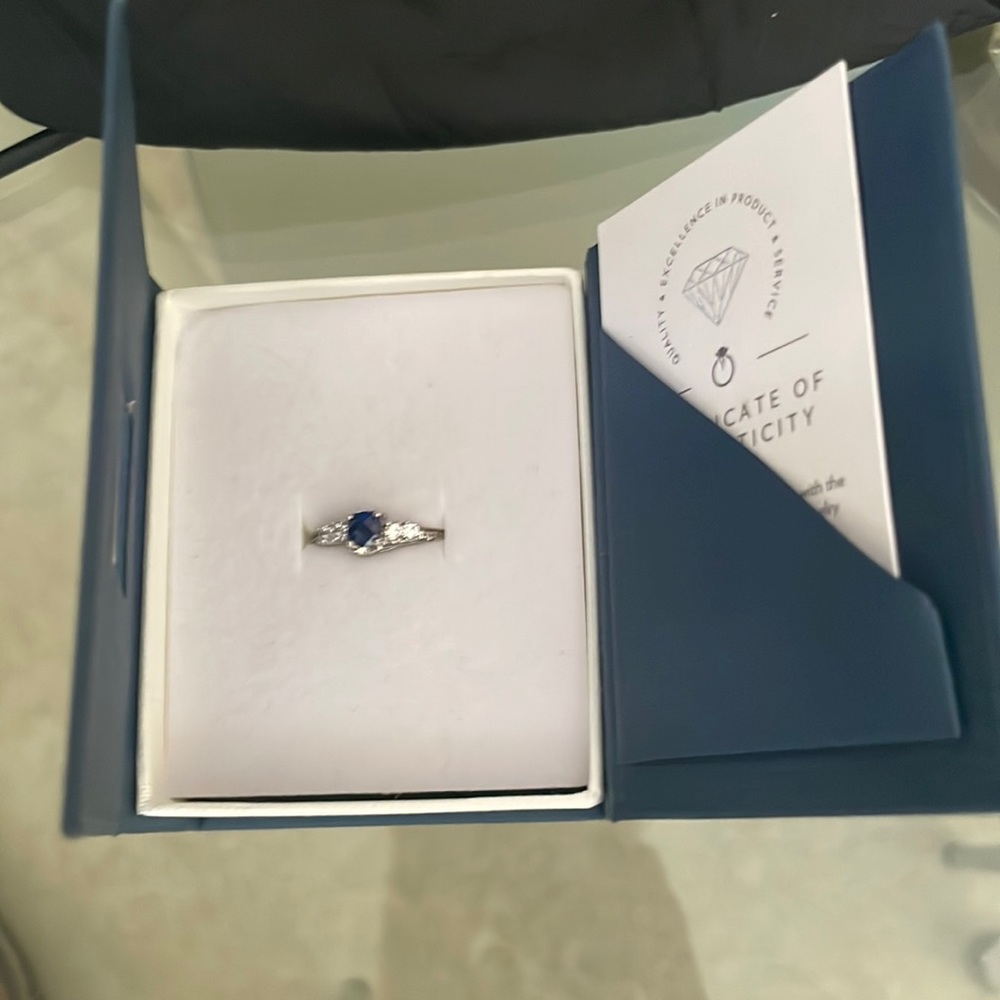Blue Diamond ring authentic has authentic Peoria certification next to it